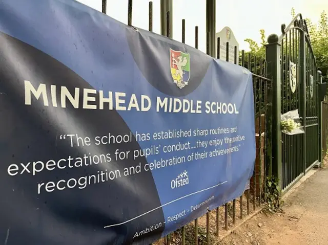 Banner of Minehead Middle School on black gates