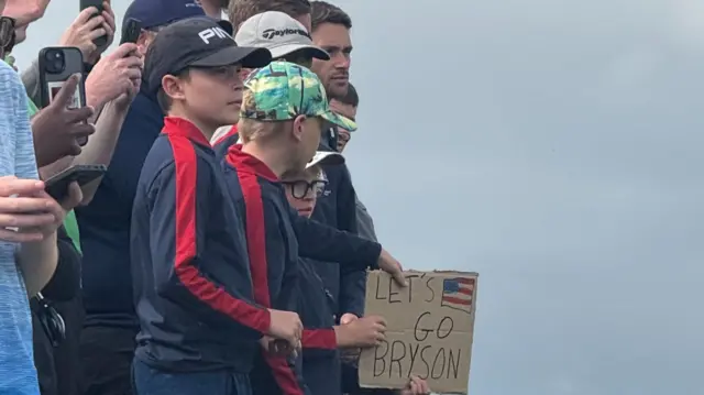 Spectators with a sign for Bryson DeChambeau