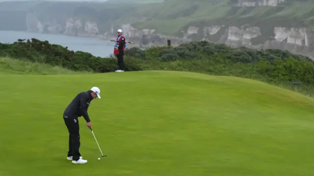 Matt Fitzpatrick putts across the green