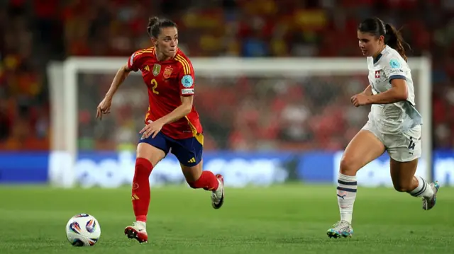 Ona Batlle of Spain runs with the ball whilst under pressure from Noemi Ivelj of Switzerland