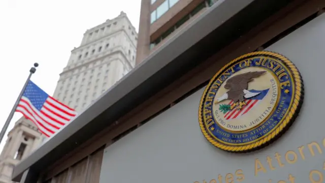 The seal of the United States Department of Justice is seen on the building exterior of the United States Attorney's Office of the Southern District of New York in Manhattan
