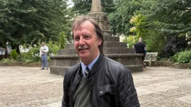 Jack Russell standing outside St Mary Redcliff Church ahead of the funeral of David "Syd" Lawrence