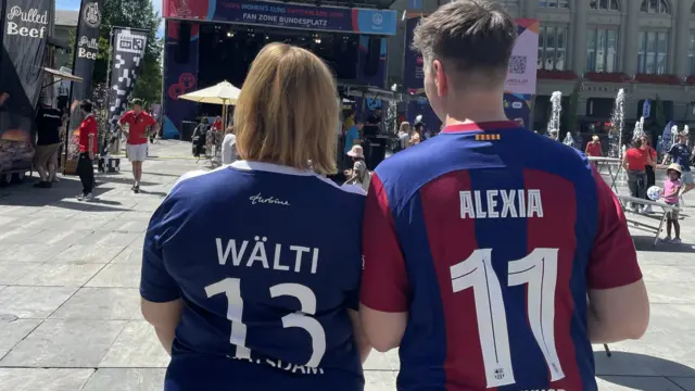 German couple, Christin and Anja, wearing opposition shirts