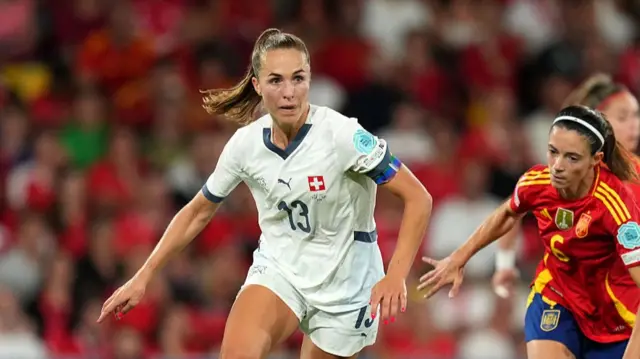 Lia Waelti of Switzerland runs with the ball under pressure from Aitana Bonmati of Spain