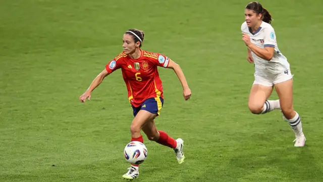 Aitana Bonmati of Spain runs with the ball whilst under pressure from Noemi Ivelj of Switzerland