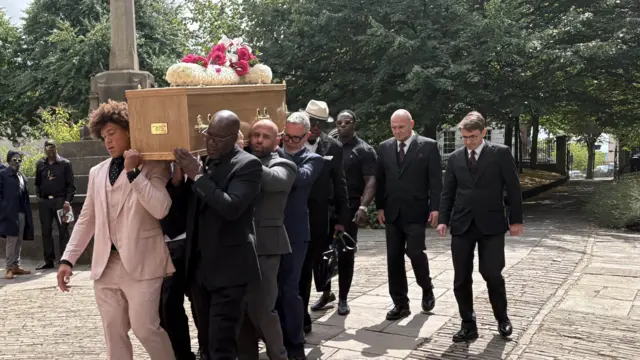 Lawrence's son among those carrying coffin