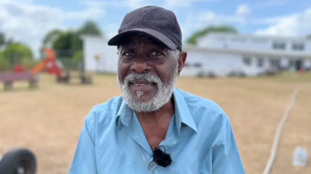 Guy Reid-Bailey smiling into the camera.