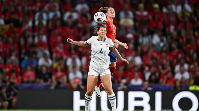 Switzerland's midfielder Noemi Ivelj goes for a header with Spain's defender Ona Batlle