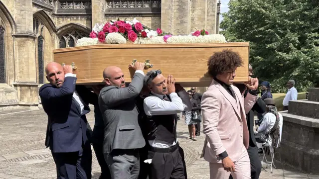 The coffin of Lawrence being carried out of the church.