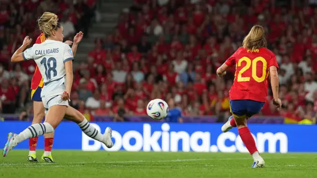Claudia Pina of Spain scores her team's second goal under pressure from Viola Calligaris of Switzerland