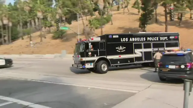A black fire engine with "LA Police Department" written on it drives into the centre