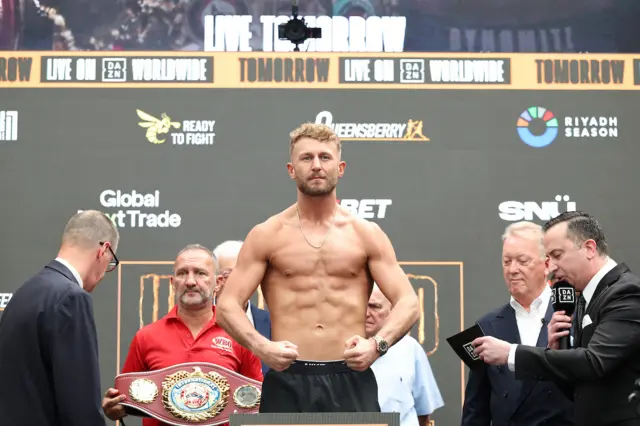 Lewis Edmondson flexes as he weighs in