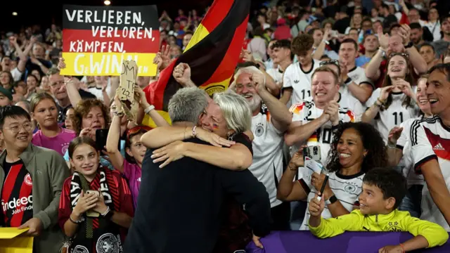 Christian Wueck, Head Coach of Germany, embraces a fan following the teams victory and progression to the semi finals