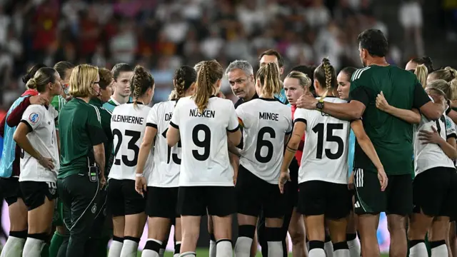 Germany's coach Christian Wueck (C) gathers Germany's players in a huddle ahead of a penalty shootout