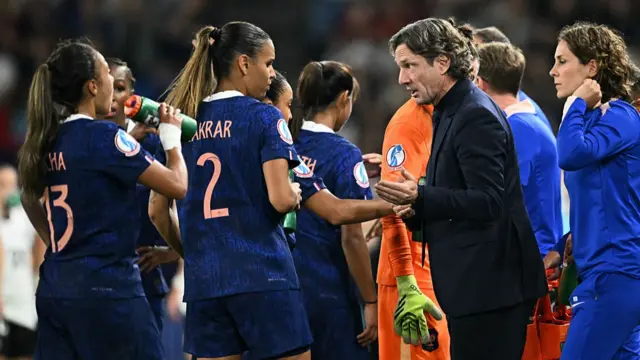 France's head coach Laurent Bonadei (2nd R) gestures as he speaks to France's players during a break in play