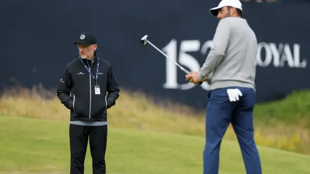 Phil Kenyon and Scottie Scheffler on a putting green at Royal Portrush