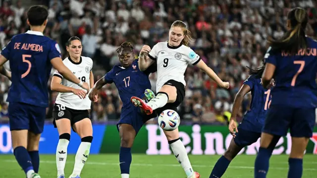 Germany's midfielder #09 Sjoeke Nuesken (C) kicks the ball.