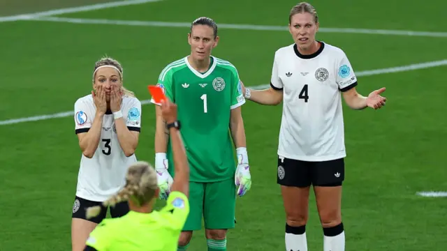 Kathrin Hendrich of Germany reacts, as she is shown a red card by Referee Tess Olofsson, as Ann-Katrin Berger and Rebecca Knaak of Germany look on