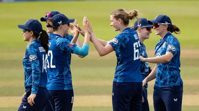 Lauren Bell of England celebrates with her team mates