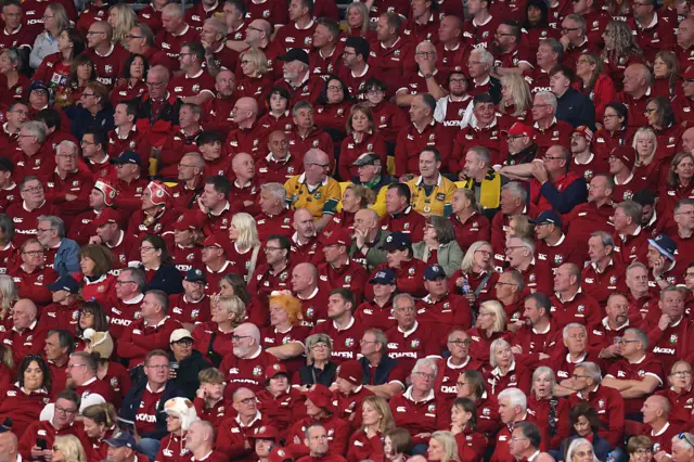 A small group of Aussie fans find themselves surrounded by Lions fans