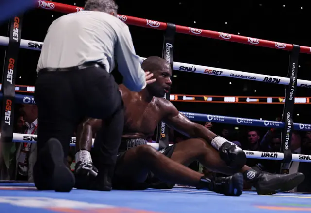The referee counts with Daniel Dubois on the canvas