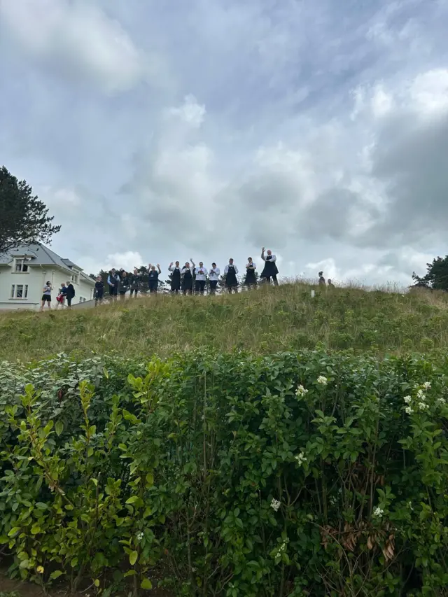People waving to the camera