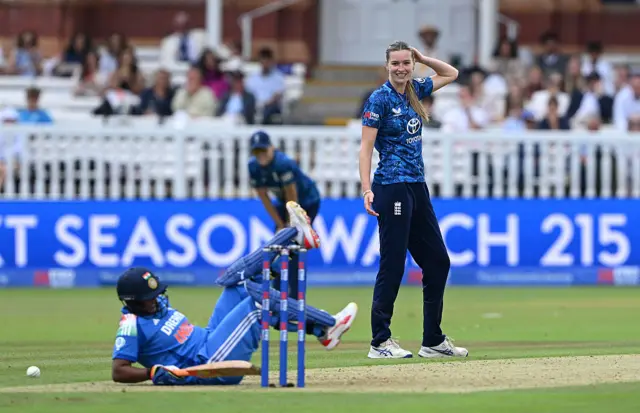 Lauren Bell of England reacts after hitting Deepti Sharma of India with the ball