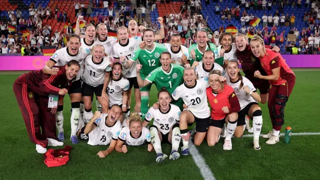 Players of Germany pose for a team photo as they celebrate after defeating France 6-5 following a penalty shootout