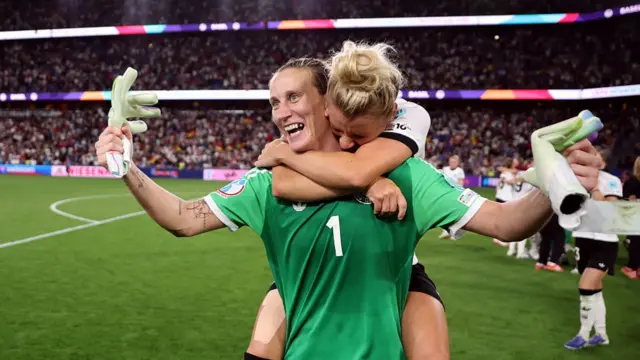 Ann-Katrin Berger of Germany is embraced by teammate Linda Dallmann as they celebrate the teams victory and progression to the semi finals