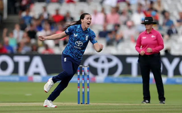 Emily Arlott of England celebrates taking the wicket of Pratika Rawal