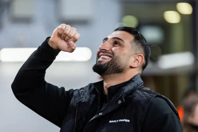Kabyel raises his fist to fans in support