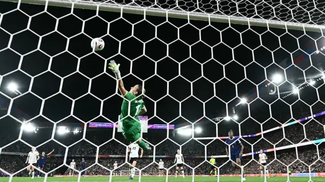 Germany's goalkeeper #01 Ann-Katrin Berger dives to stop the ball