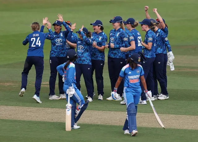 England players celebrate and Indian wicket