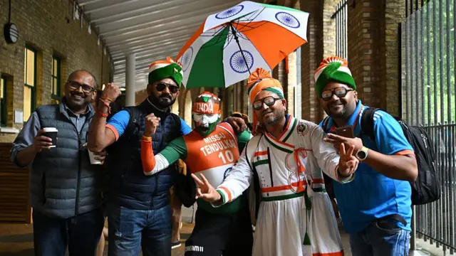 India fans stay out of the rain as play is delayed