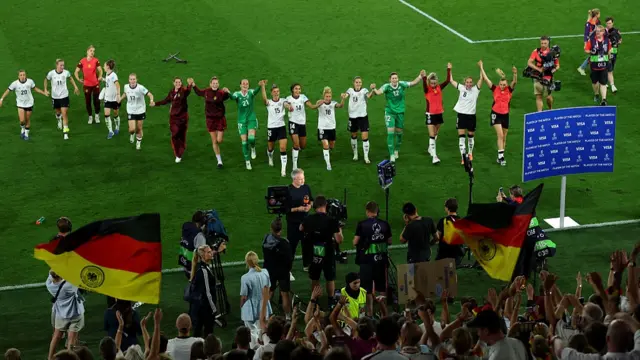 Players of Germany celebrate with fans following the team's victory in the penalty shoot out
