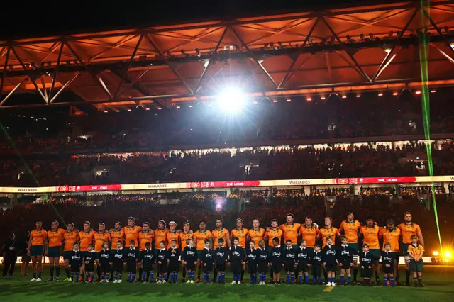 Wallabies players line up for national anthems