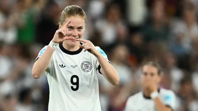 Germany's midfielder #09 Sjoeke Nuesken gestures as she celebrates after scoring her team's first goal