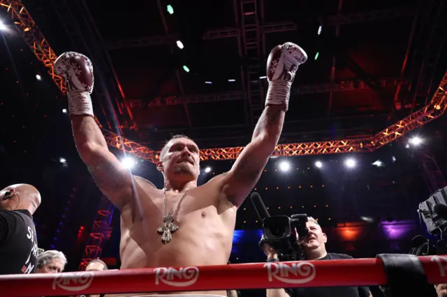 Oleksandr Usyk raises his arms