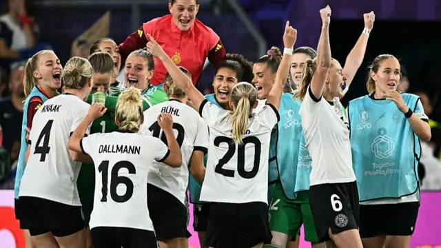 Germany's players celebrate after winning the UEFA Women's Euro 2025 quarter finals football match between France and Germany at the Parc Saint-Jacques