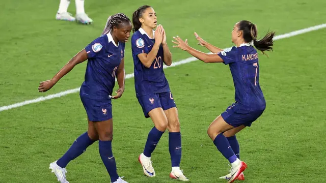 Delphine Cascarino of France reacts with teammates Kadidiatou Diani and Sakina Karchaoui after scoring her sides goal, which is later ruled offside