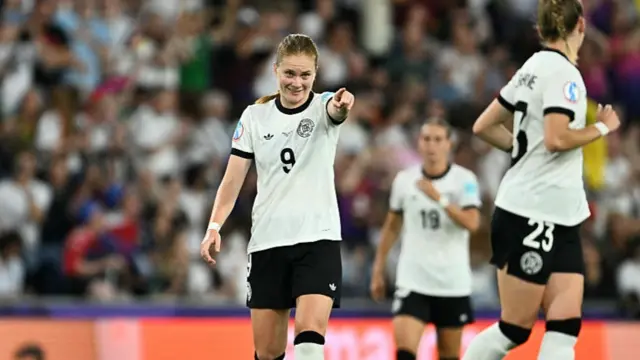 Germany's midfielder #09 Sjoeke Nuesken (L) gestures as she celebrates after scoring her team's first goal