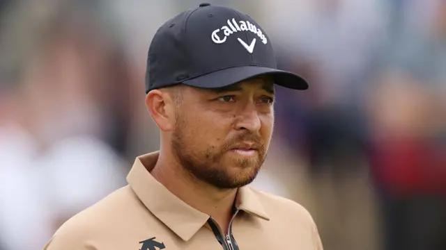 Xander Schauffele looks on in a black Callaway cap at The Open