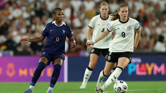 Sjoeke Nuesken of Germany is challenged by Grace Geyoro of France