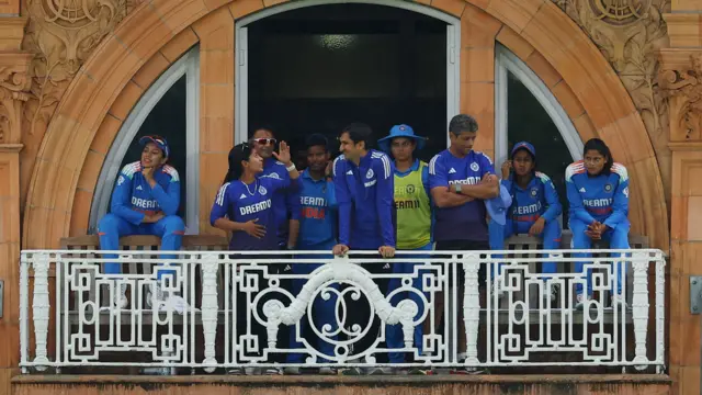India players on the balcony as rain suspends pla