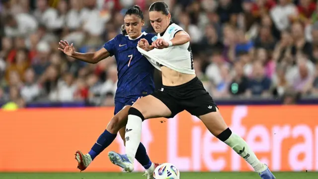 France's midfielder #07 Sakina Karchaoui and Germany's midfielder #18 Giovanna Hoffmann fight for the ball