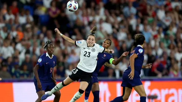 Sophia Kleinherne of Germany and Grace Geyoro of France compete for a header