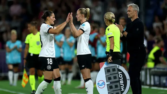 Giovanna Hoffmann of Germany interacts with Lea Schueller of Germany after being substituted off