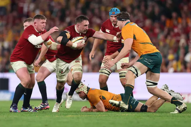 Jack Conan of British and Irish Lions tries to hand off Nick Frost of Australia