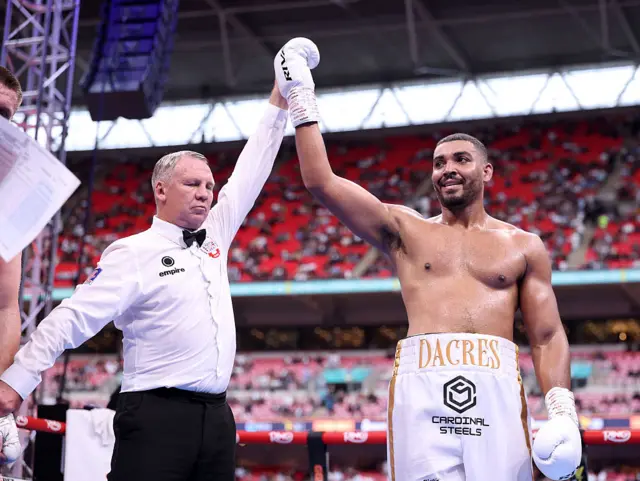 Referee Bob Williams raises the arm of Solomon Dacres