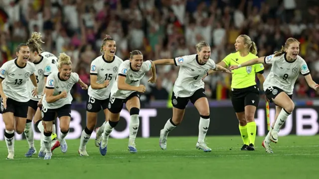 Players of Germany celebrate after Ann-Katrin Berger of Germany (not pictured) saves the seventh penalty from Alice Sombath of France